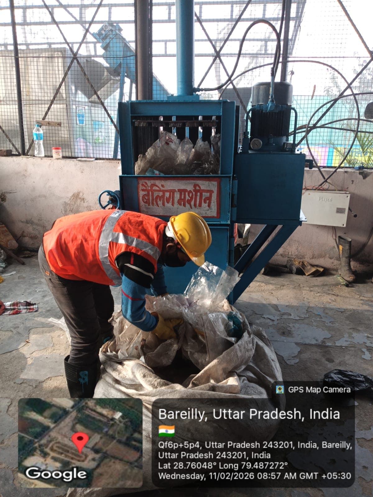 Worker operating a baling machine