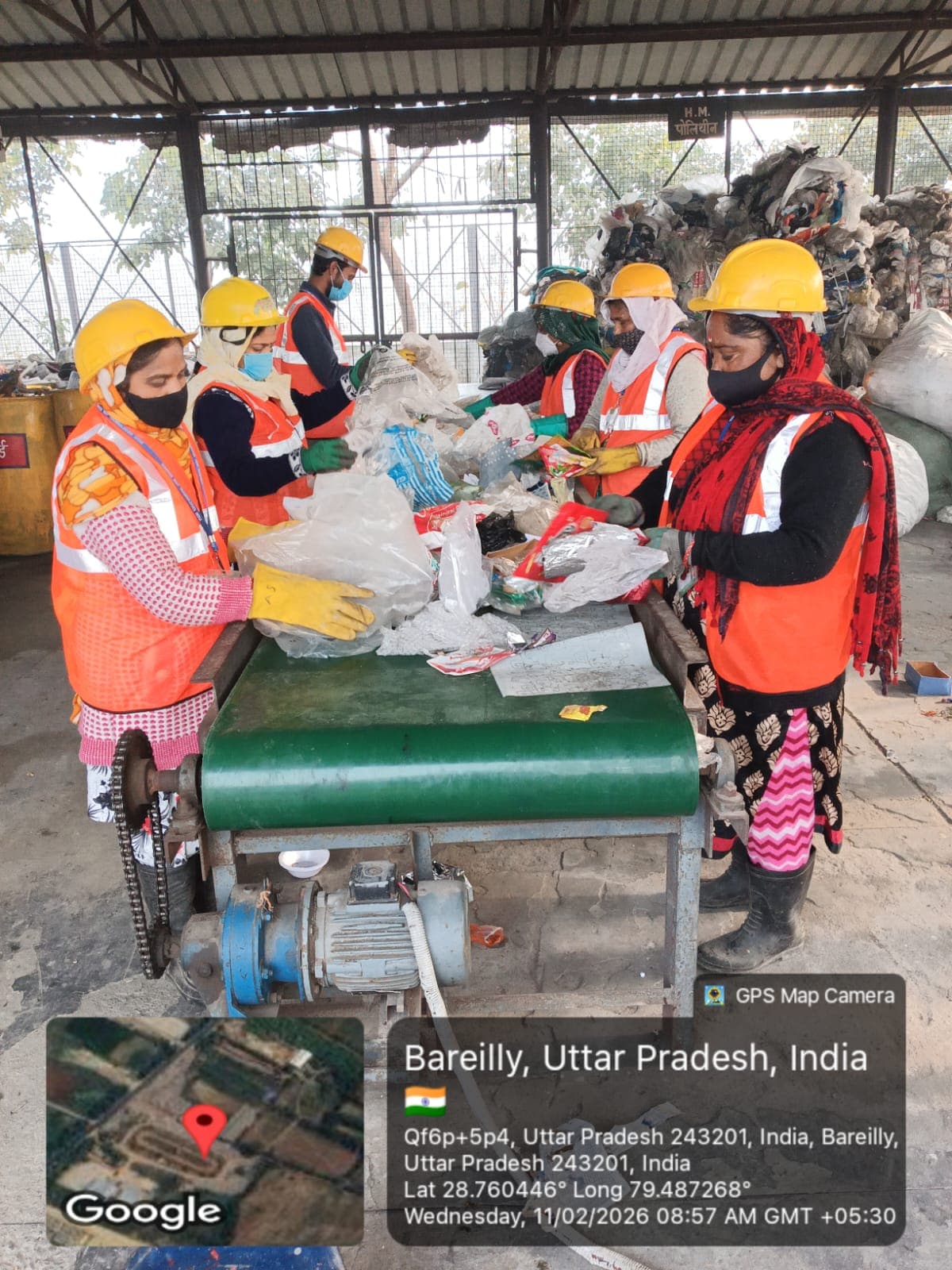 Workers sorting waste on a conveyor belt